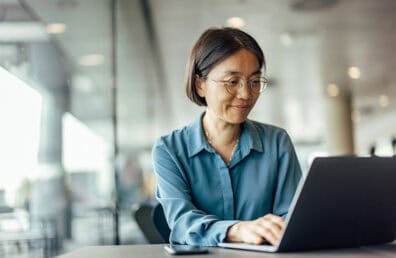 A woman working on a laptop.