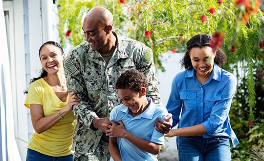navy veteran walking with family, laughing