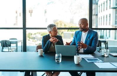 Business, presentation and man on a laptop in a corporate conference or office collaboration with a woman at work