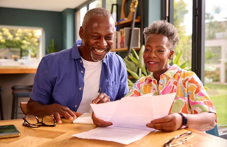 An older couple looking over financial documents.