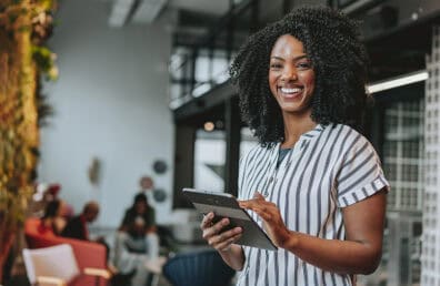 Business woman holding digital tablet smiling
