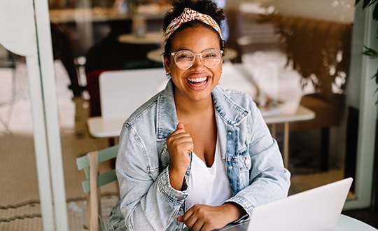 Business woman smiling at computer