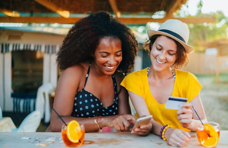 friends splitting the bill at a restaurant in the summer on the patio