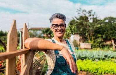 Portrait of a mature woman on a community garden entrance