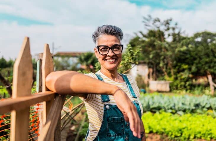 Portrait of a mature woman on a community garden entrance