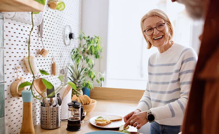 Retired couple making breakfast in their kitchen