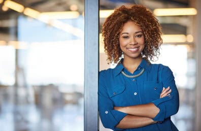 A young and confident businesswoman smiling at the camera.
