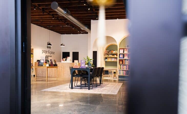 page & pine bookstore lobby with table, chairs, and books