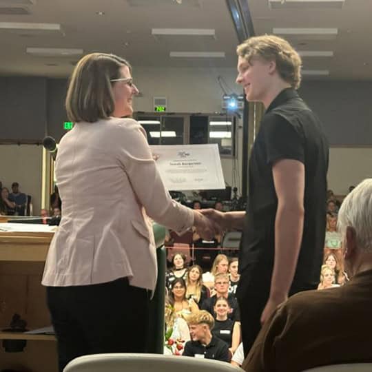 Claire White, VP/Business Deposits at Sound presenting Jonah Bergerson with his scholarship recognition.