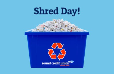 A recycle bin filled with shredded paper, on a sky blue background.